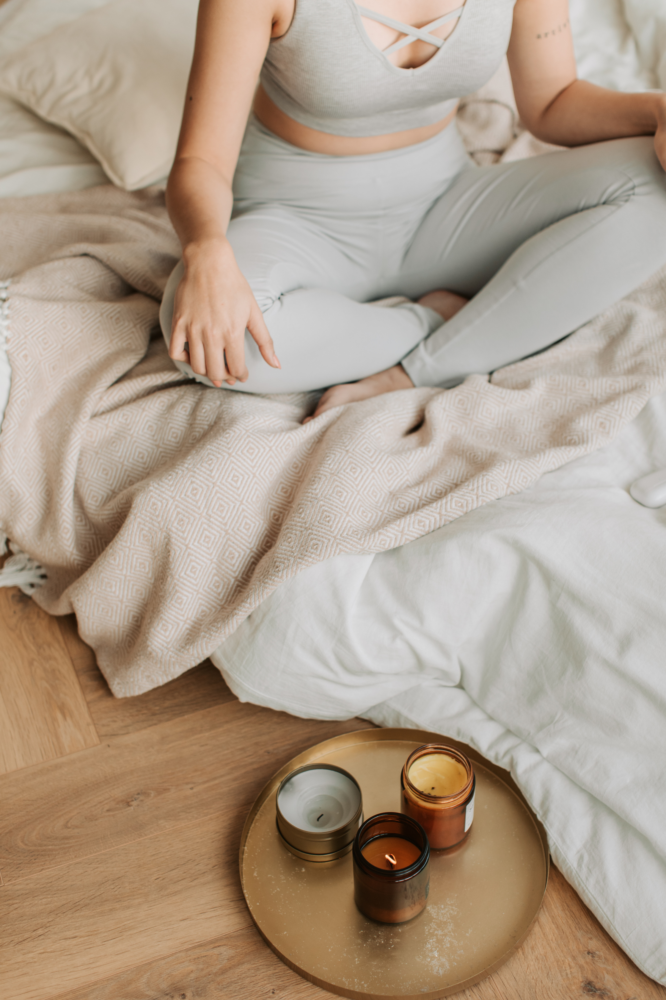 Woman Meditating at Home with Candles